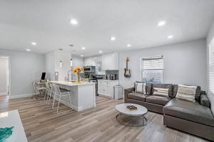 a living room and kitchen with a couch and a table at Casita Delray in Delray Beach