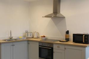 a kitchen with a counter top with a microwave at Kidsty Pike in Bowness-on-Windermere