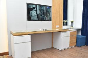 a dressing table with a tv on top of it at Loaloat maadi Hostel "Cornich Elnile" in Cairo