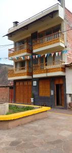 a building with a yellow ramp in front of it at La Casa de la Abuela I in Yucay