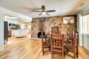 a dining room with a table and a brick wall at Pinetop-Lakeside Cabin, Walk to Woodland Lake Park in Pinetop-Lakeside