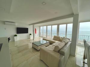 a living room with a couch and a view of the ocean at Texas in Alicante