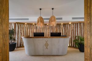 a lobby with a reception desk in a building at Le Sidi - A TLT Signature Hotel in El Alamein