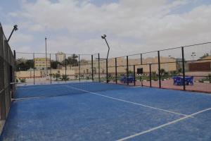 a tennis court with a net on a tennis court at Loaloat maadi Hostel "Cornich Elnile" in Cairo