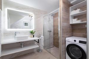 a bathroom with a sink and a washing machine at Apartment Ena Arena Pula in Pula