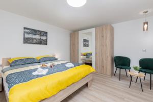 a bedroom with a bed and two chairs and a desk at Apartment Ena Arena Pula in Pula