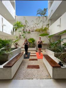 two women walking down the stairs of a building at 369 "THE BEST APARMENTS NEAR 5TH AV " UrbanTowers in Playa del Carmen