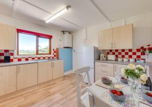 a kitchen with a table and chairs in a room at Resthaven in Ilfracombe