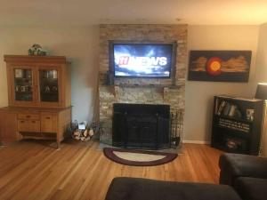 a living room with a fireplace with a tv and a television at Beautiful Perfectly Located Hot Tub Fire Pit Bikes in Colorado Springs