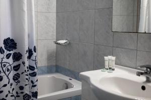 a bathroom with a sink and a bath tub at Home Sweet Home Unique Sea View in Sivota