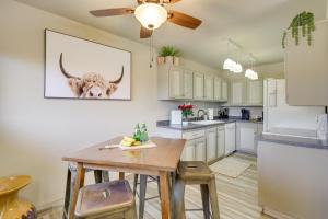 a kitchen with a table and a cow on the wall at Yuma Vacation Rental with Community Pool! in Yuma