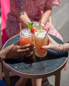 a group of people holding drinks on a table at Fauchon l'Hôtel Paris in Paris