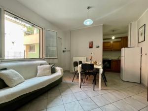 a living room with a couch and a table and a refrigerator at La tua Vacanza al Mare in Borghetto Santo Spirito +35 photos
