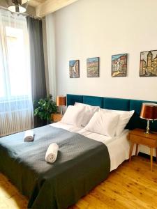 a bedroom with a large bed with a blue headboard at Florianska Deluxe Apartments with Air Condition in Krakow