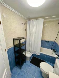 y baño con aseo, bañera y lavamanos. en Capitan Friday Apartments, en Torrevieja