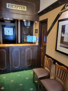 a train car with two chairs and a bar at The Quorn in Skegness