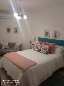 ein Schlafzimmer mit einem großen Bett und einem Sofa in der Unterkunft Apto Cortegada in Vilagarcia de Arousa