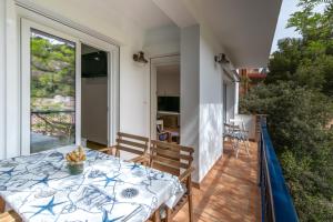 a dining table on the balcony of a house at La caseta de Sa Riera in Begur