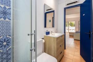 a bathroom with a toilet and a sink and a mirror at La caseta de Sa Riera in Begur +12 photos