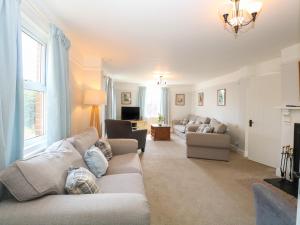 a living room with two couches and a fireplace at Riverside Cottage in Norwich