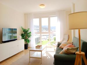 a living room with a couch and a television at El Mirador 2 in Viveiro