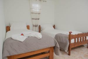 a bedroom with two beds with white towels on them at House Angelina in Galiá