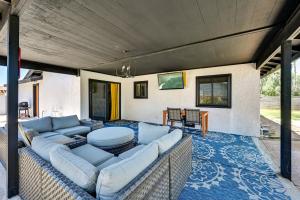 a living room with a couch and a table at Yuma Vacation Rental with Private Pool and Patio! in Yuma