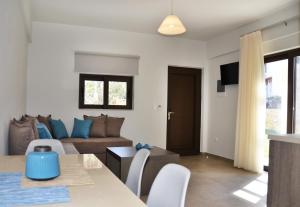 a living room with a couch and a table at Ledra Maleme Hotel in Maleme