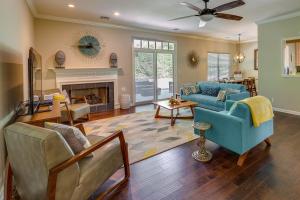 a living room with two blue couches and a fireplace at North Bentonville Vacation Rental Near Bike Trails in Bentonville