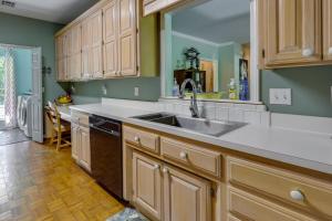 a kitchen with wooden cabinets and a sink at North Bentonville Vacation Rental Near Bike Trails in Bentonville