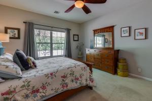 a bedroom with a bed and a dresser and a window at North Bentonville Vacation Rental Near Bike Trails in Bentonville