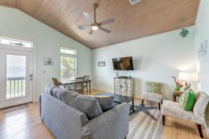 a living room with two couches and a ceiling fan at Eskridge Gem Unit B in Port Aransas
