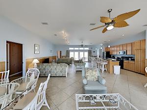 a living room with a couch and a table and chairs at Sea'Scape in Pensacola Beach