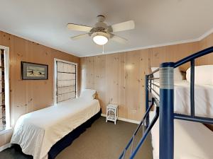 a bedroom with two beds and a ceiling fan at Sea'Scape in Pensacola Beach