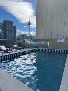 a swimming pool on the roof of a building at Prestige Hyde Park Studio Apartment in Sydney