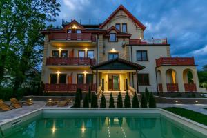 a house with a pool in front of it at ETA APARTMENT in Palić