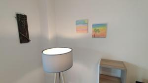 a white room with a table and a stool at To Helidoni Apartment & Gardens in Nikiti