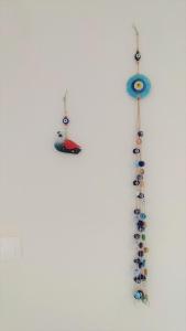 a group of earrings hanging on a wall at To Helidoni Apartment & Gardens in Nikiti +56 photos