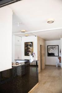 a kitchen with a black counter and a painting on the wall at Olive Island in Larnaka