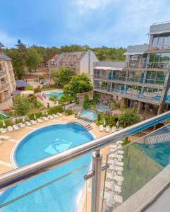 a view of a pool from a balcony of a resort at Hotel Kamenec in Kiten