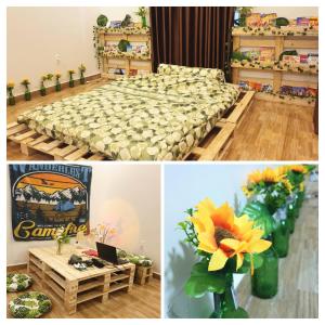 een kamer met een bed en een tafel met bloemen bij Mihome in Hai Phong