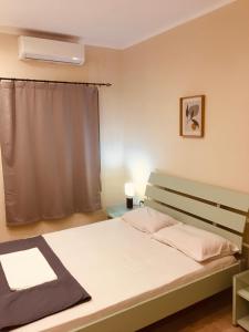 מיטה או מיטות בחדר ב-Casa Mersini