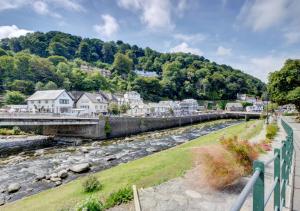 a bridge over a river in a small town at River Cottage in Lynmouth