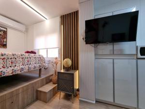 a bedroom with a bed and a flat screen tv at Estudio Brisa del Poniente Aguadulce in Aguadulce