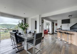 a kitchen and living room with a table and chairs at Rock House in Ilfracombe