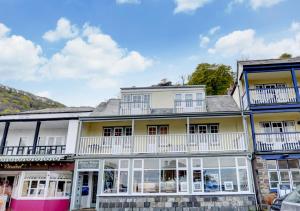 a building with white windows and balconies at River View in Lynmouth