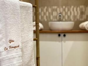 a towel hanging in a bathroom with a sink at Gîte le Fouquet in Cilaos