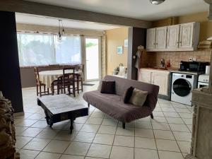 a living room with a couch and a table at Le Marcelou in Entraigues-sur-la-Sorgue