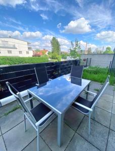 une table et des chaises assises sur une terrasse dans l'établissement Near Lake Spacious & Furnished Beautiful Apartment, à Vienne
