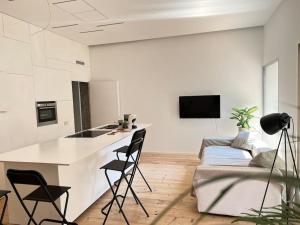 een keuken en een woonkamer met een aanrecht en stoelen bij STUDIO 14 - due biciclette incluse in Treviso